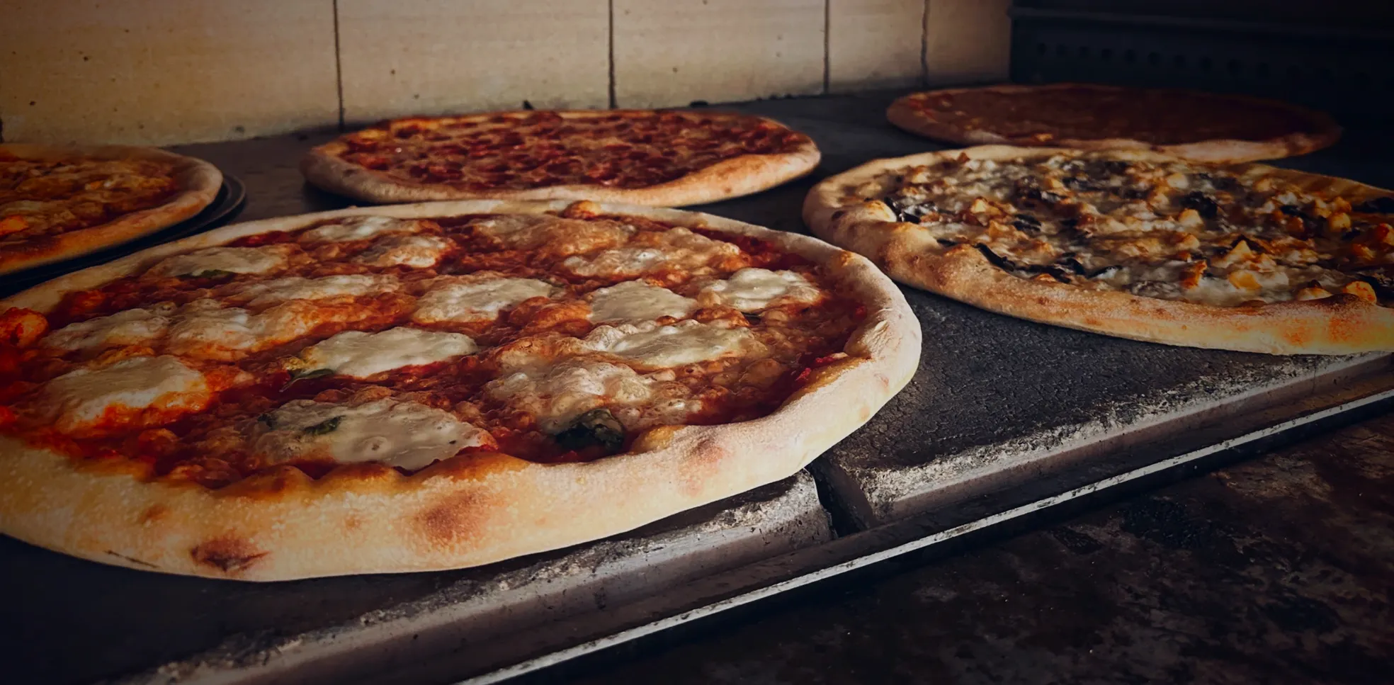 Fresh pizzas baking in the 10 Pizza oven